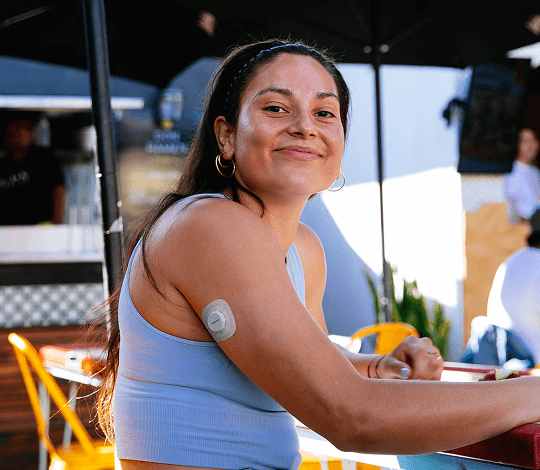 Woman wearing the Dexcom 15 day sensor