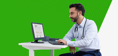 Healthcare provider sitting at his desk and looking up Dexcom formulary coverage on his computer