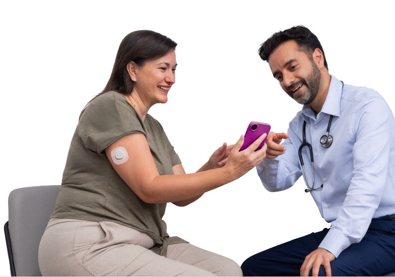 Woman wearing Dexcom G7 CGM sensor on arm and reviewing glucose data on the phone with her doctor.